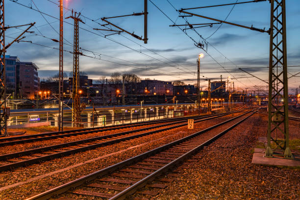 Sunny sunset evening with railways and electric poles in station Dresden Germany 03 03 2024