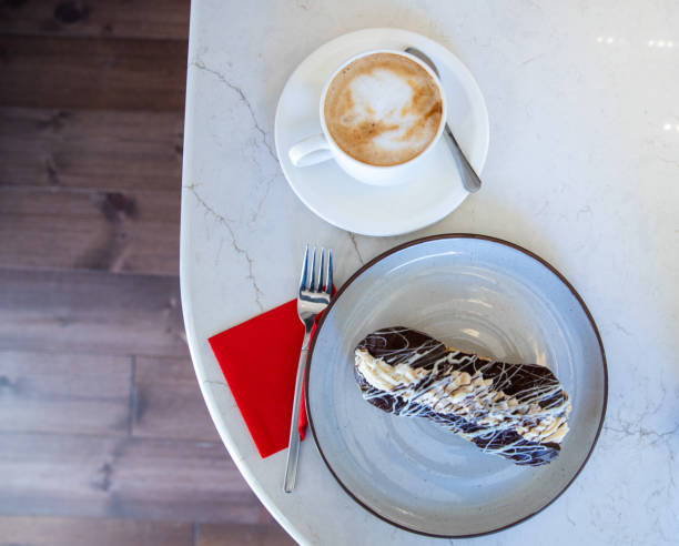 overhead angle of Eclair and a cup of coffee