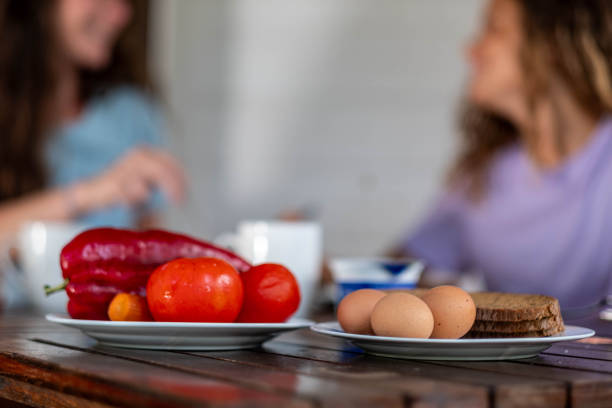 mom and dauther have breakfast on the terrace on a sunny day