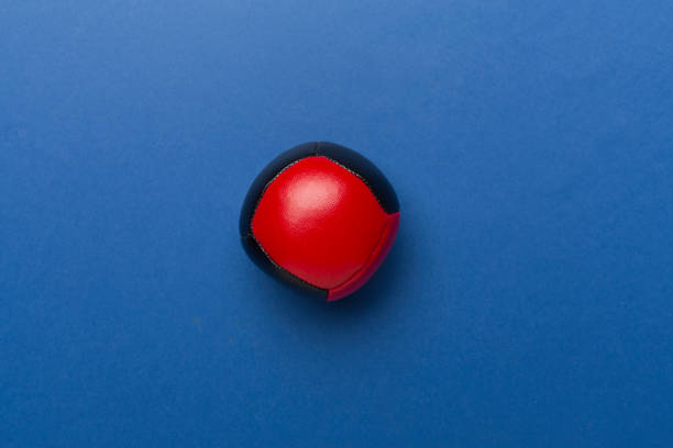 Colorful juggling ball on color background, top view