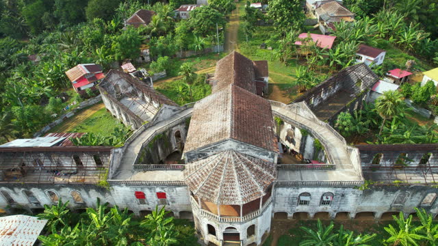 Aerial view rising in front of the Old Hospital in Roça Agua Izé, sunny Sao Tome