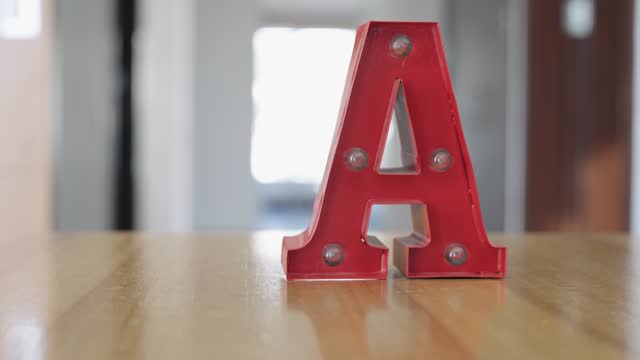 Red Letter 'A' on Wooden Desk