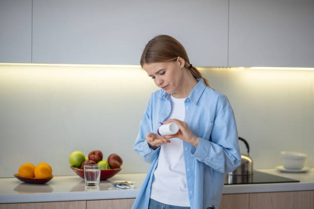 istock Woman taking pills at home 2074234976