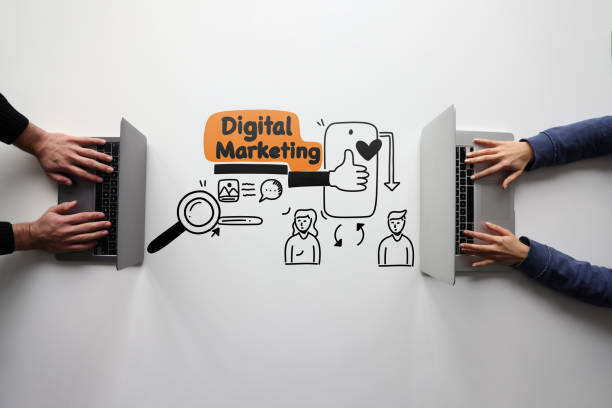 istock Two people trying to create digital content on their computers with line icons 2074240699