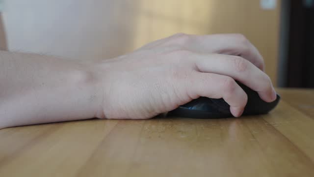 Hispanic Man's Hand Operating Computer Mouse