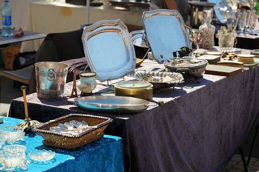 Nice, France - April 24, 2023: Many items were on sale at one of the stalls during the outdoor flea market at Cours Saleya in the old town.