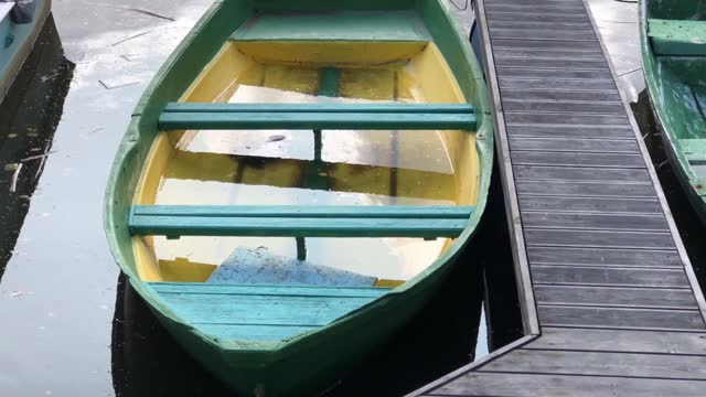 rowing boat filled with rainwater