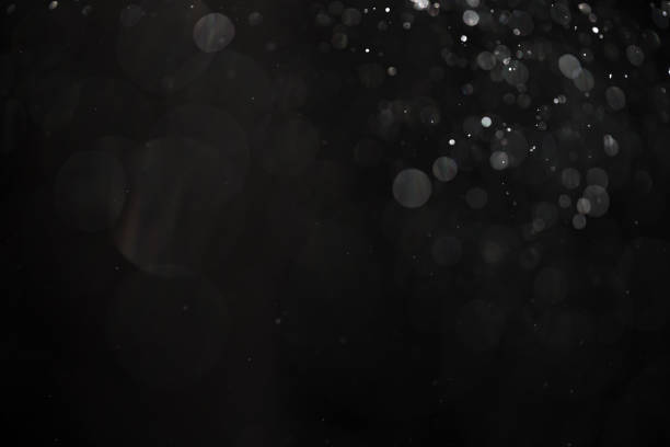 istock abstract real dust floating over black background for overlay 2074300943