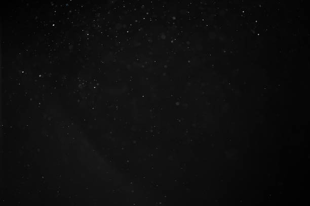 istock abstract real dust floating over black background for overlay 2074302503