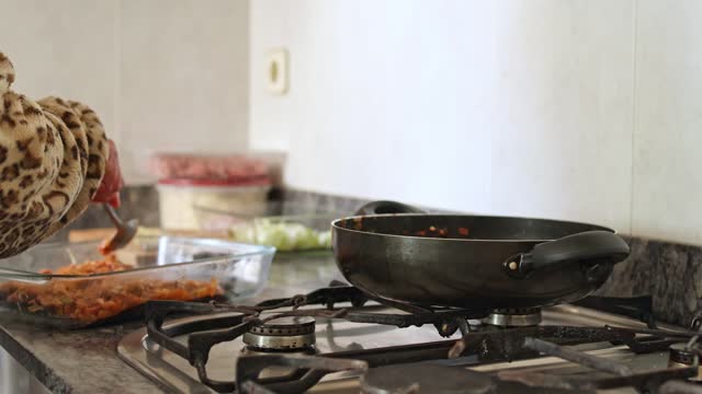 unrecognizable woman cooking homemade food at home