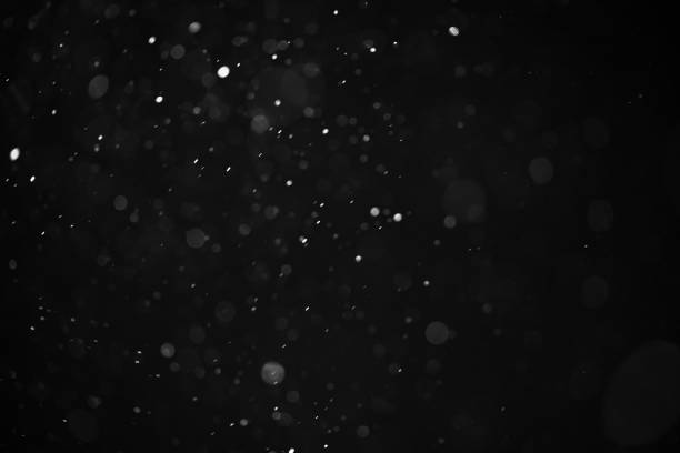 istock abstract real dust floating over black background for overlay 2074304072