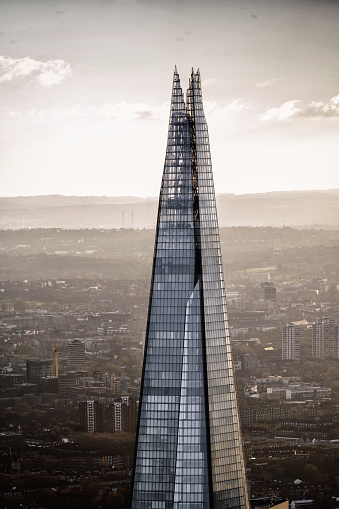 On a cloudy winter day, a panoramic urban view unfolds across the London rooftops, extending towards the towering Shard skyscraper—an international landmark in Southwark, London.