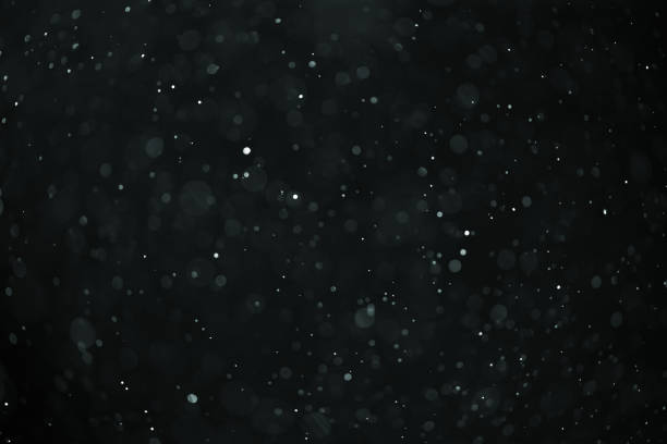 istock abstract real dust floating over black background for overlay 2074320079