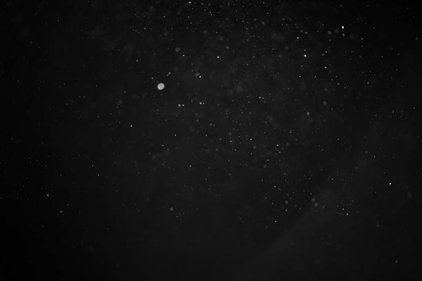 istock abstract real dust floating over black background for overlay 2074321645