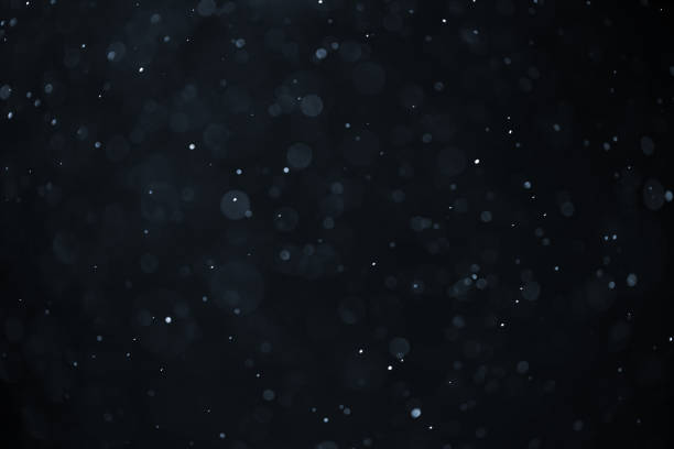 istock abstract real dust floating over black background for overlay 2074333908