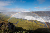 Majestic rainbow over Dettifoss waterfall in Iceland on a spring day