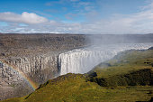 Majestic rainbow over Dettifoss waterfall in Iceland on a spring day