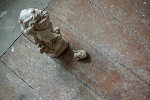 small and broken statue of a virgin