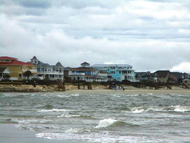 Good Harbor Beach is a picturesque and popular destination located in Gloucester, Massachusetts. It is renowned for its stunning natural beauty, expansive sandy shoreline, and serene coastal atmosphere. Situated along the Atlantic Ocean, Good Harbor Beach offers visitors a quintessential New England coastal experience.\n\nThe south end of Good Harbor Beach in Gloucester MA looks over a rocky promontory known as  Bass Rock. \n\nThe large, white cottage is known as Sherman Cottage, built in the 1880's, and from 1907 to 1950 the summer home of the royal legation of Siam (Thailand.)