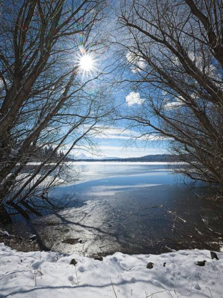 The sun shines down on partially frozen Hauser Lake on a winter day in Hauser, Idaho.
