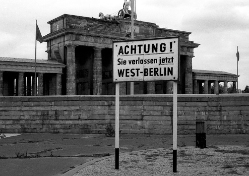 Barrier wall the GDR at the Brandenburg Gate in Berlin with a warning sign Attention  You are now leaving West Berlin. - Germany.