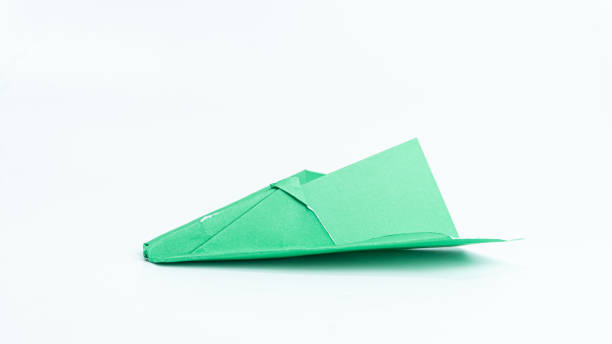 istock Green paper airplane isolated on white background 2074510159