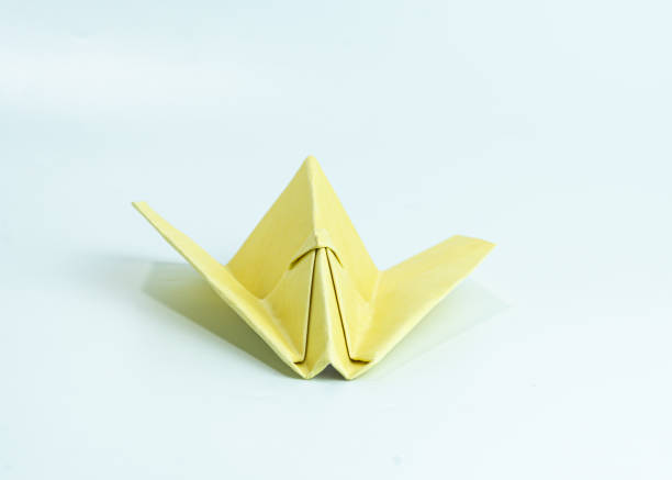 Yellow paper airplane isolated on white background