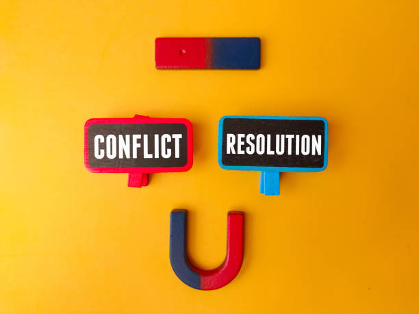 istock Magnet and wooden board with the word CONFLICT RESOLUTION 2074514396