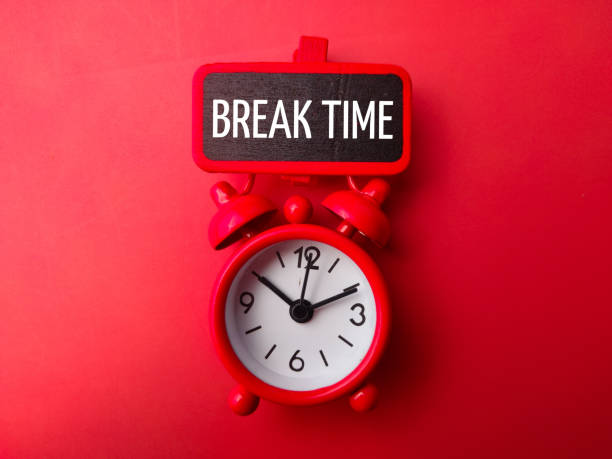 istock Alarm clock and wooden board with the word BREAK TIME 2074514912