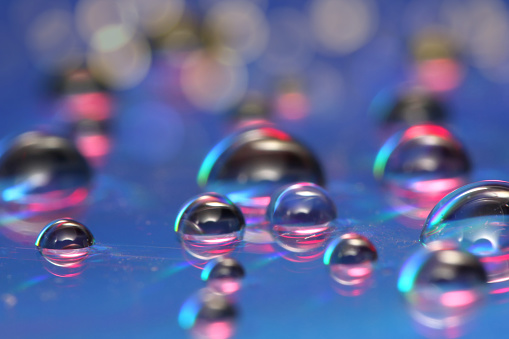 Beautiful and colorful abstract water dropped on the reflection surface. Bokeh, shiny, suitable for wallpaper, template, overlay layer.