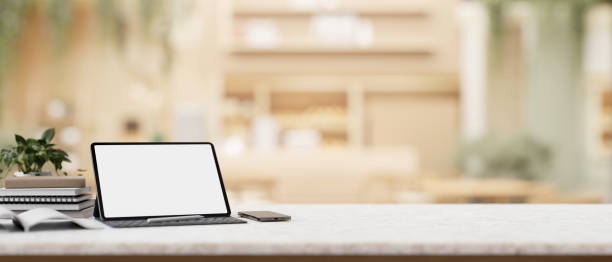 istock A digital tablet white-screen mockup with a wireless keyboard on a table in a cosy coffee shop. 2074659910