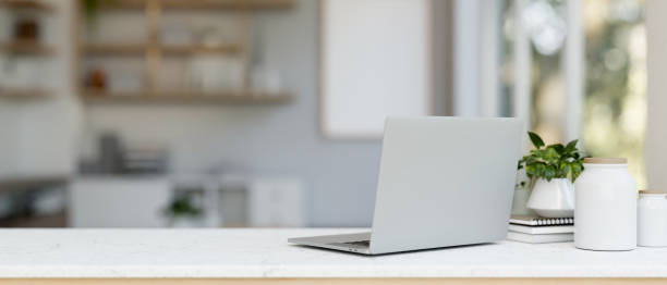 istock A back view image of a laptop computer and decor on a white table in a modern and clean office. 2074661517