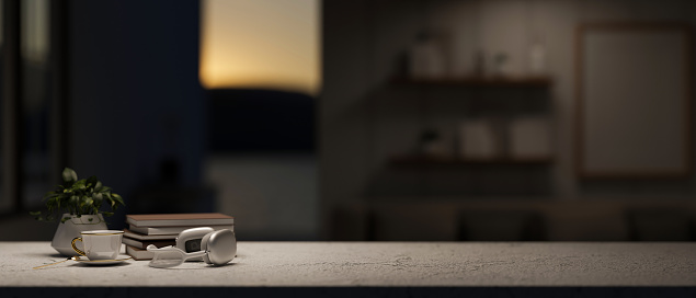 A presentation space for display products on a tabletop features headphones, a coffee cup, books, and a decor plant in a modern dark room. 3d render, 3d illustration