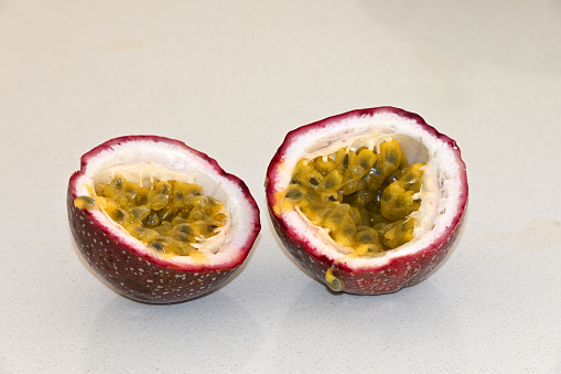 Passionfruit cut in half on the kitchen bench