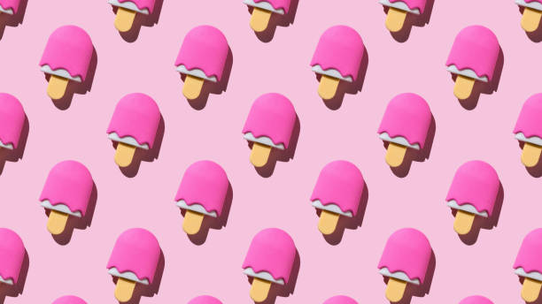 istock A summer pattern of berry popsicle on a pink background. 2074692939