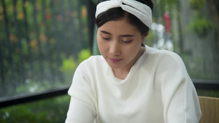 Businesswoman hands type on laptop writing on notebook meeting at office desk. Asian Woman Hands writing planning on office paper use calendar from laptop. Female hand holding pen work Business Plan