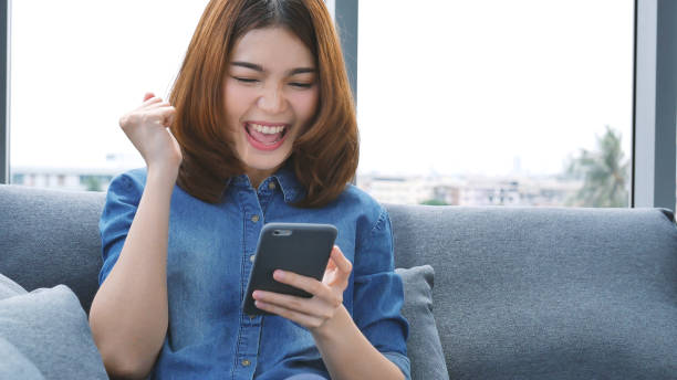 istock Asian woman using digital tablet shopping online, call, texting message internet technology lifestyle with smiling face. Asian woman touch smart tablet focus on hands using mobile app home office. 2074695280