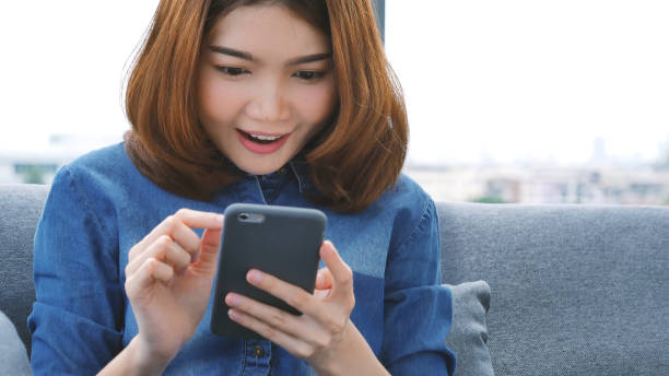 istock Asian woman using digital tablet shopping online, call, texting message internet technology lifestyle with smiling face. Asian woman touch smart tablet focus on hands using mobile app home office. 2074695281
