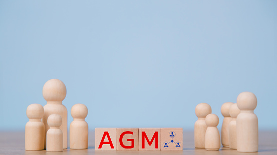 Conceptual image of a group of people with the word AGM. business concept. AGM annual general meeting