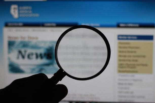 istock newspaper under a magnifying glass With copy space for commercial text.with selective focus. 2074751042