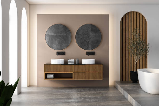 istock Modern minimalist bathroom interior, modern bathroom cabinet, white sink, wooden vanity, interior plants, bathroom accessories, bathtub and, white and wooden walls, concrete floor. 2074756360
