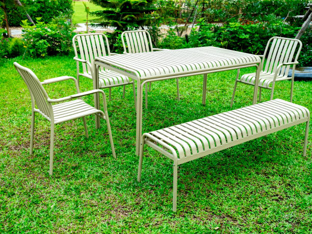 istock Modern minimal table set, table, bench and armchair seat, stripes pattern, beige color, iron materials on green grass decoration at the outdoor backyard garden landscape background, no people. 2074765739