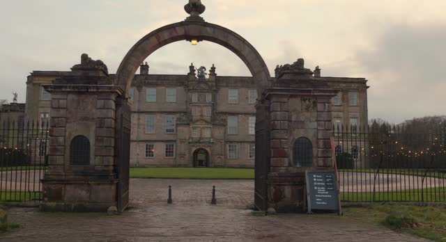 Panning view over the arched entrance to Lyme house in Disley, Cheshire, UK.