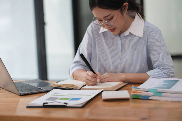 istock Young hardworking businesswoman writing her idea before the meeting. 2074785151