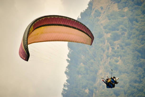 paraglider circling in the cloudy sky