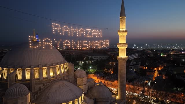 Happy Ramadan Feast Text in the Suleymaniye Mosque, Illuminated Letters Between Minarets (Mahya) Drone Video, Suleymaniye Fatih, Istanbul Turkiye (Turkey)