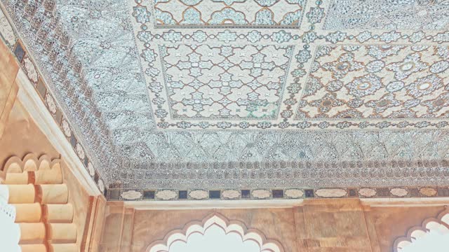 Beautiful walls and ceiling ornate with mirrors of the Interior of Shish Mahal (Palace of Mirrors)