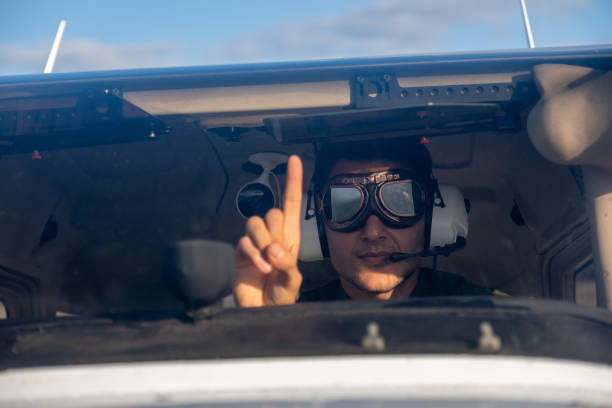 young pilot candidate receiving flight training meets with the tower - avionics flying training cockpit fotografías e imágenes de stock