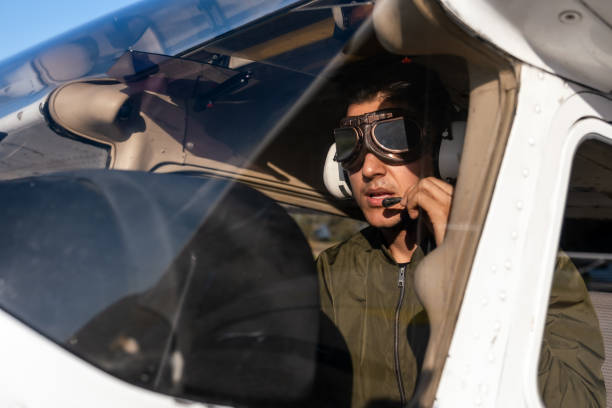 young pilot candidate receiving flight training meets with the tower - avionics flying training cockpit fotografías e imágenes de stock