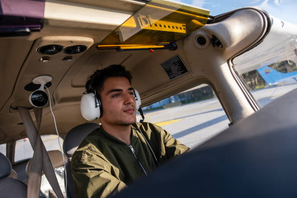 young pilot candidate receiving flight training meets with the tower - avionics flying training cockpit fotografías e imágenes de stock